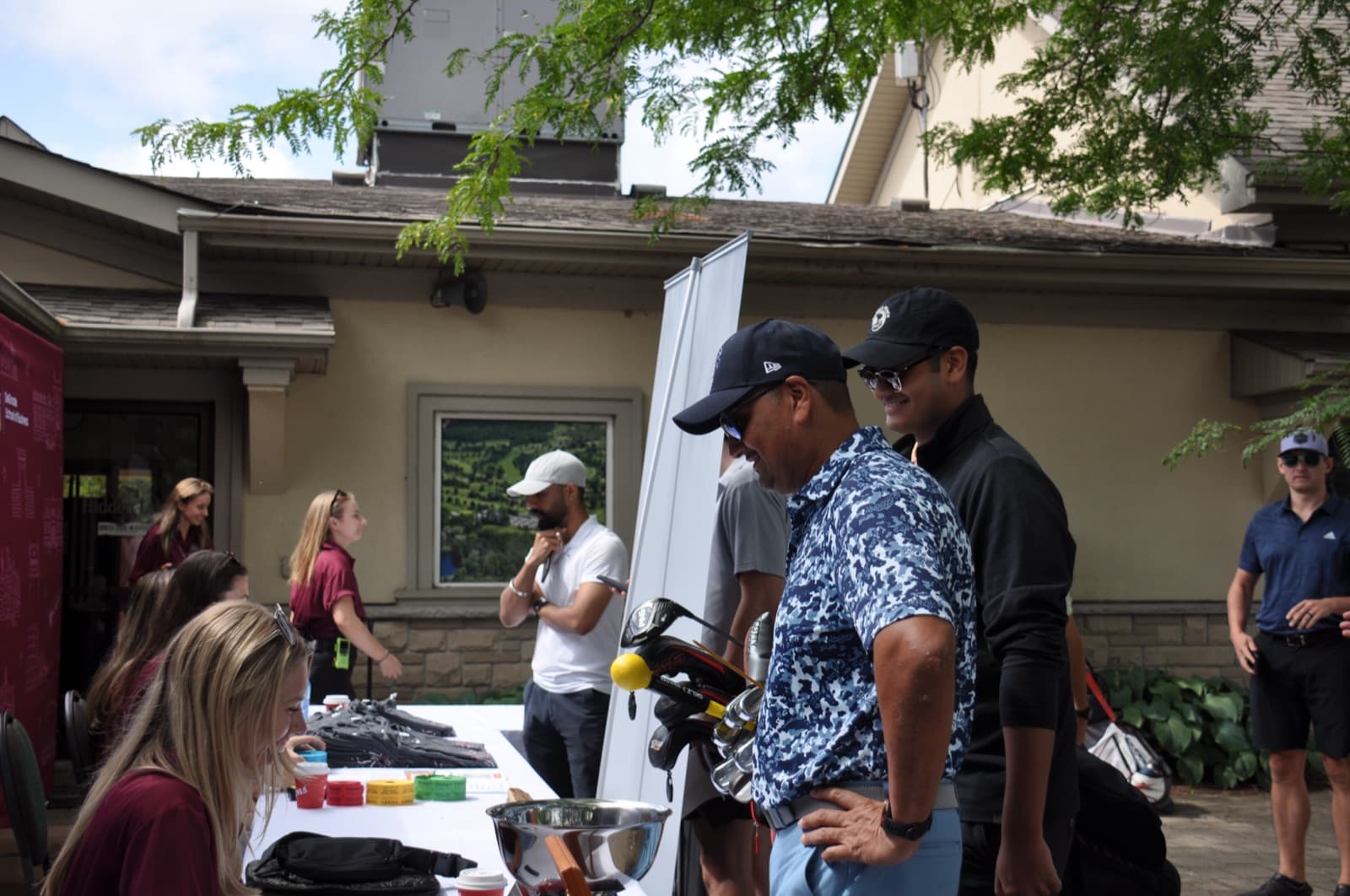 The registration desk with golf clubs on display