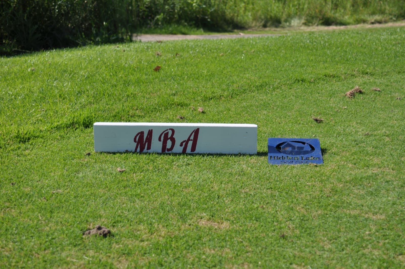 White tee block reading MBA on the tee deck